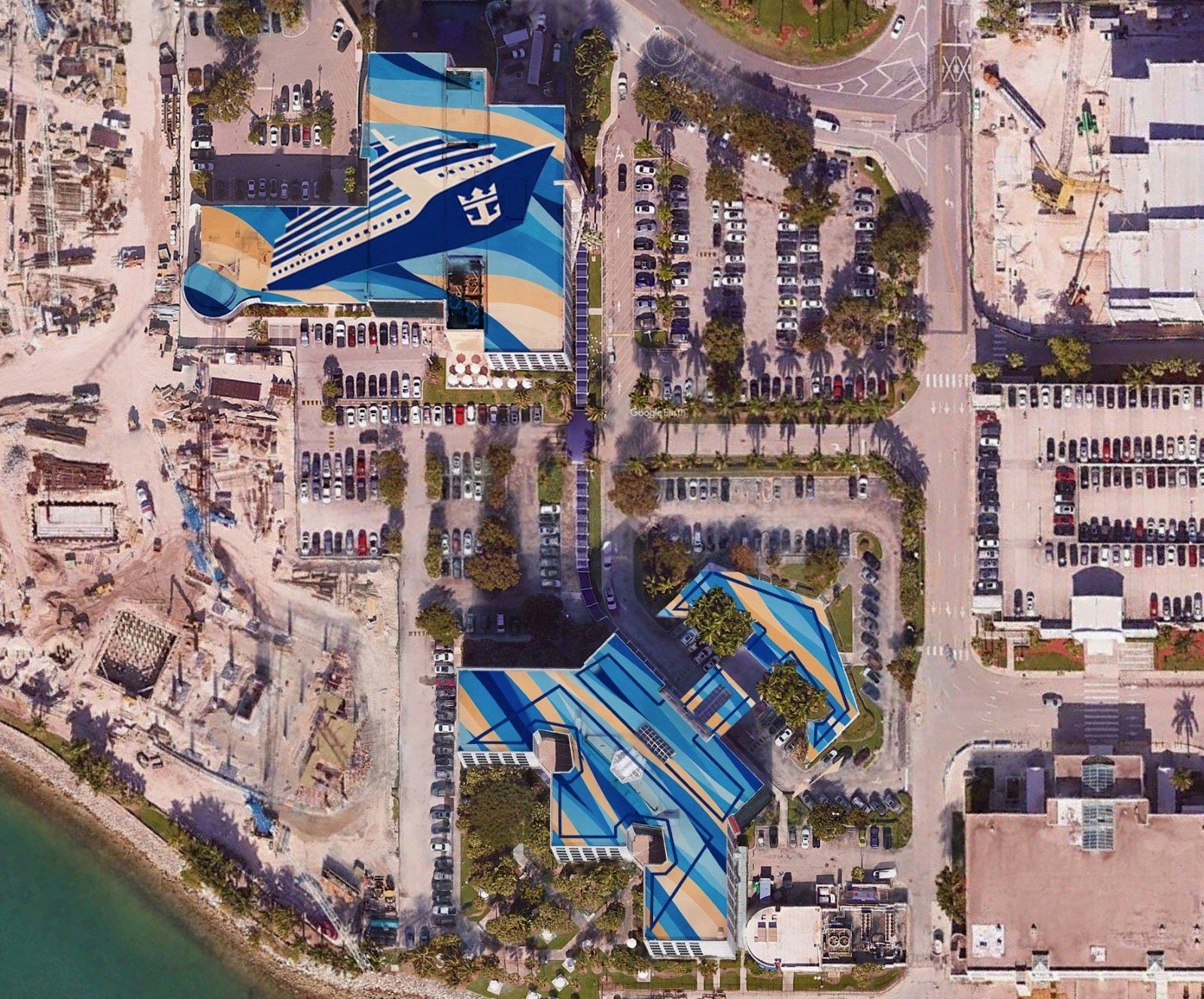 Aerial view of the full Royal Caribbean campus with artwork across three connected roofs